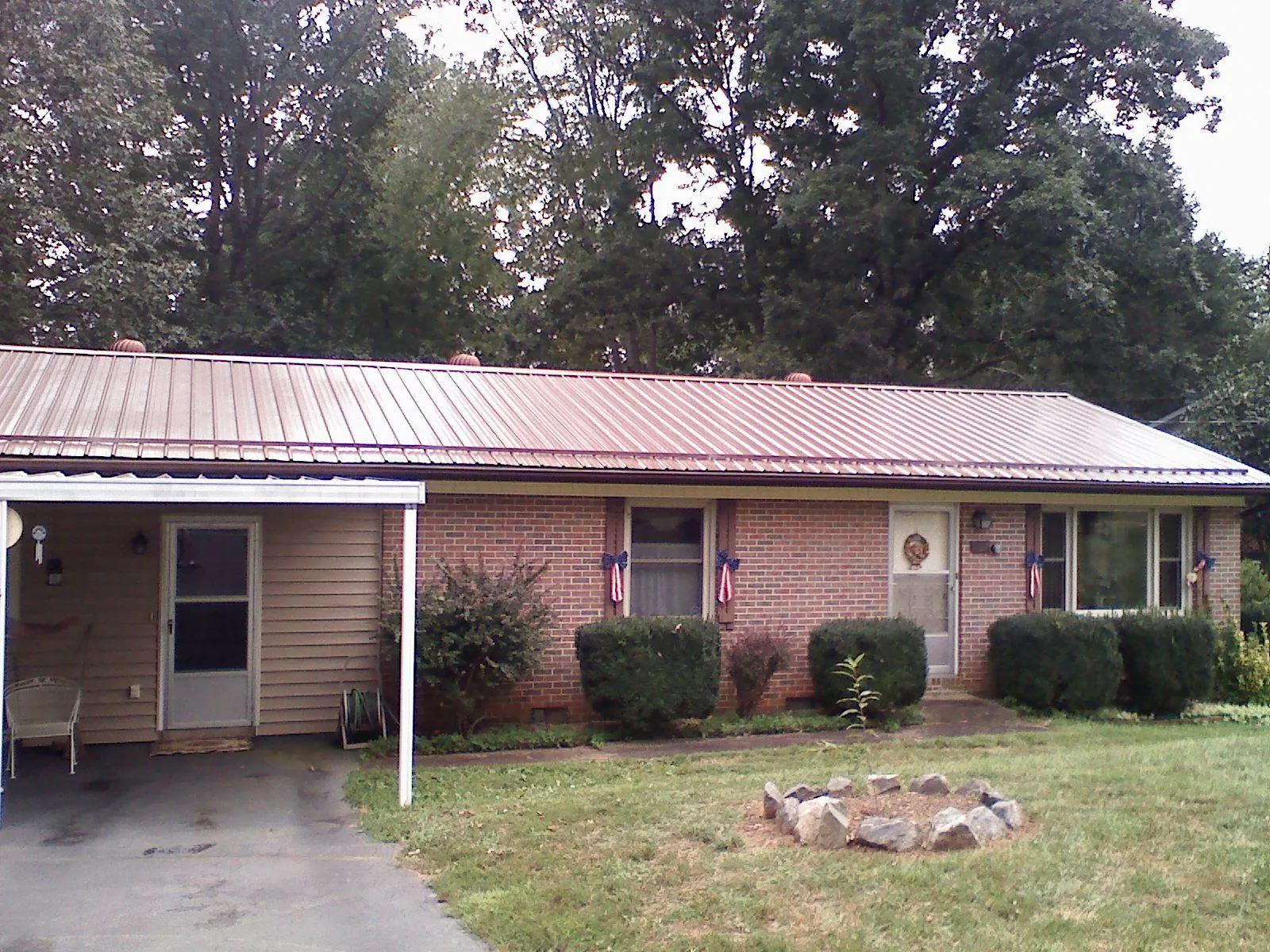 Bronze metal roof and carport on a brick ranch home — Roof Repair work by our crew in New Athens
